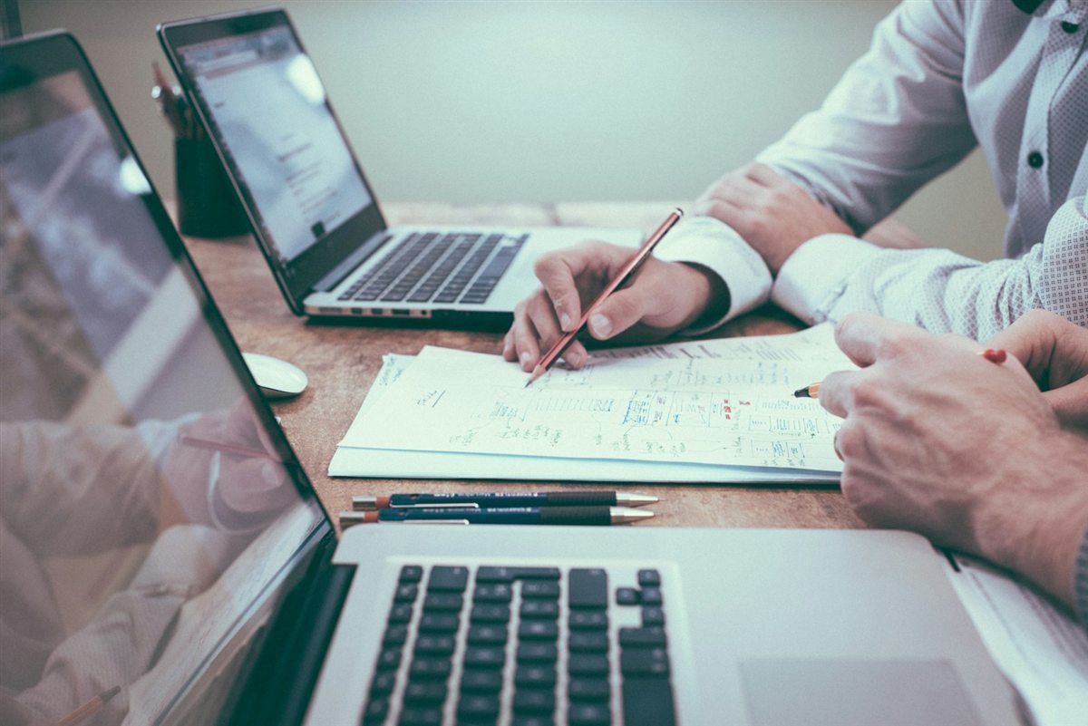 Small business owner working in an office while reviewing general liability insurance costs