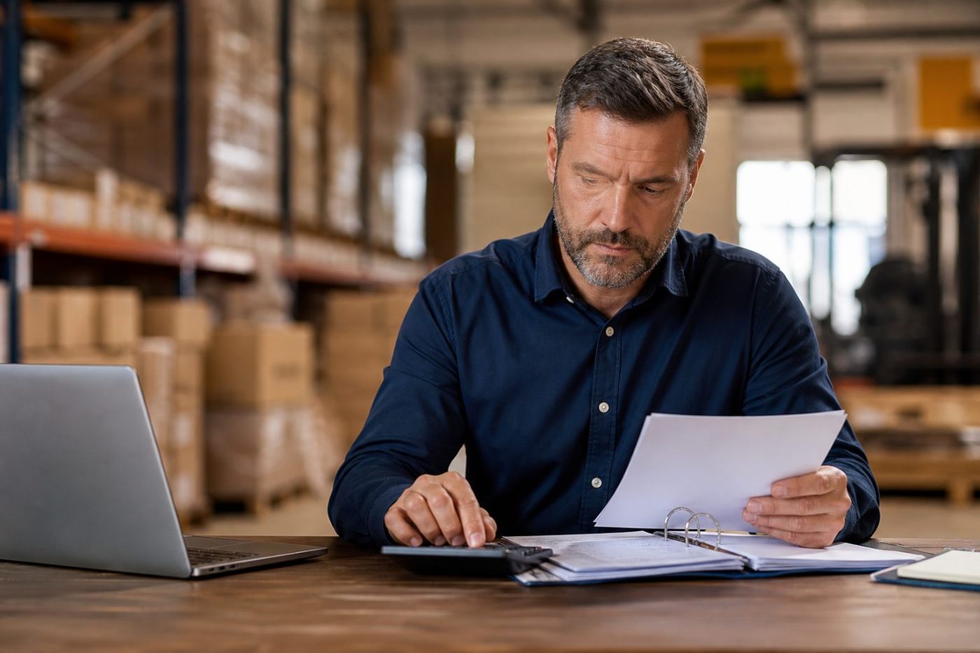 Business owner comparing workers comp insurers and policy quotes