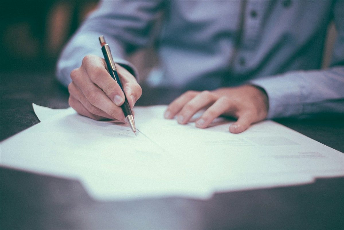 Life insurance policy documents and planning checklist on a desk